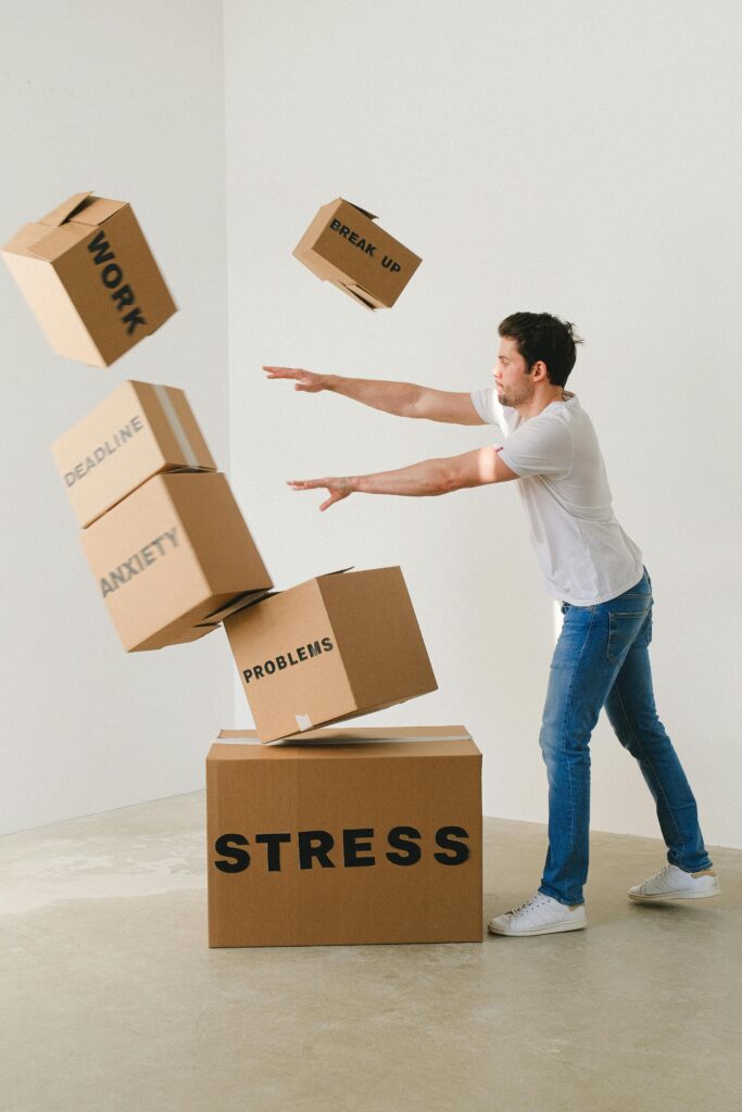 Effects of Manipulation on Adolescents: Take charge with Cognitive Psychotherapy Full body of young man in sneakers and jeans pushing and falling boxes saying Work Problems Anxiety Stress and Deadline while fighting with problems